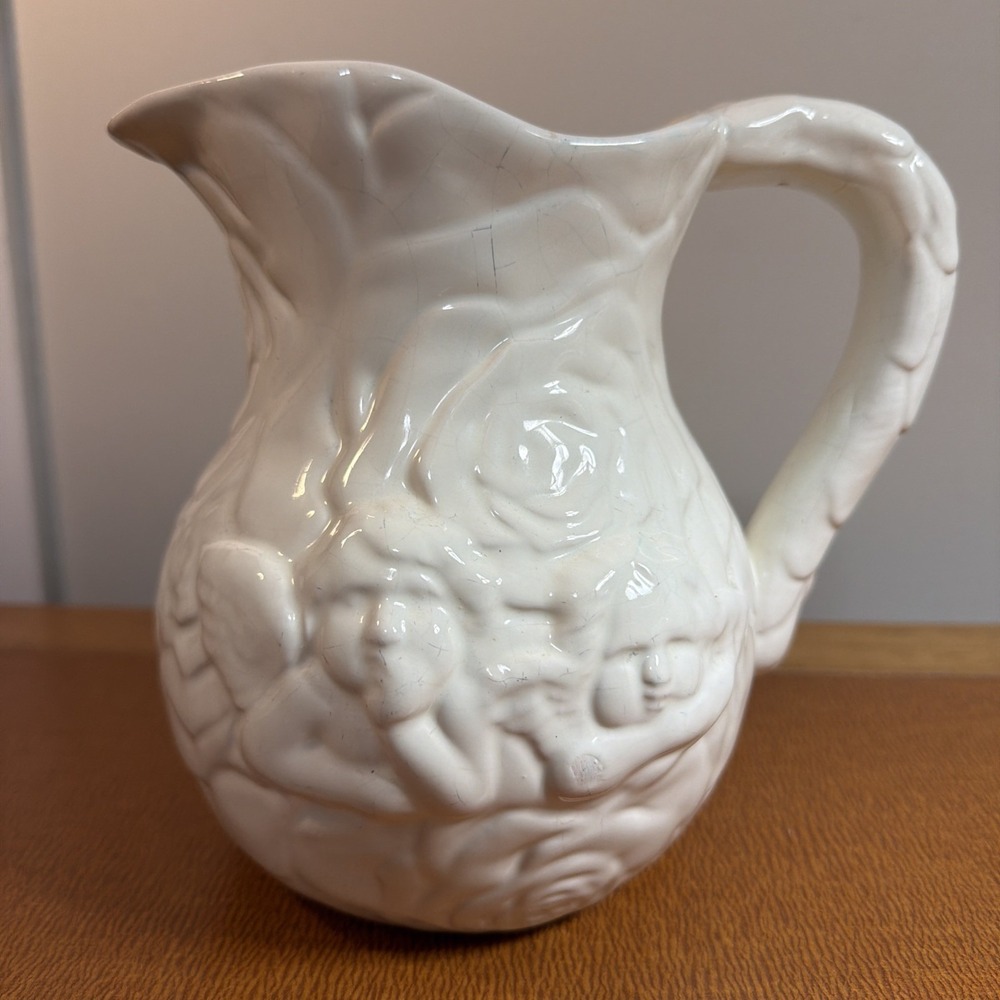 Vintage White Ceramic Pitcher with Raised Cherub Figures 7.25x 6"